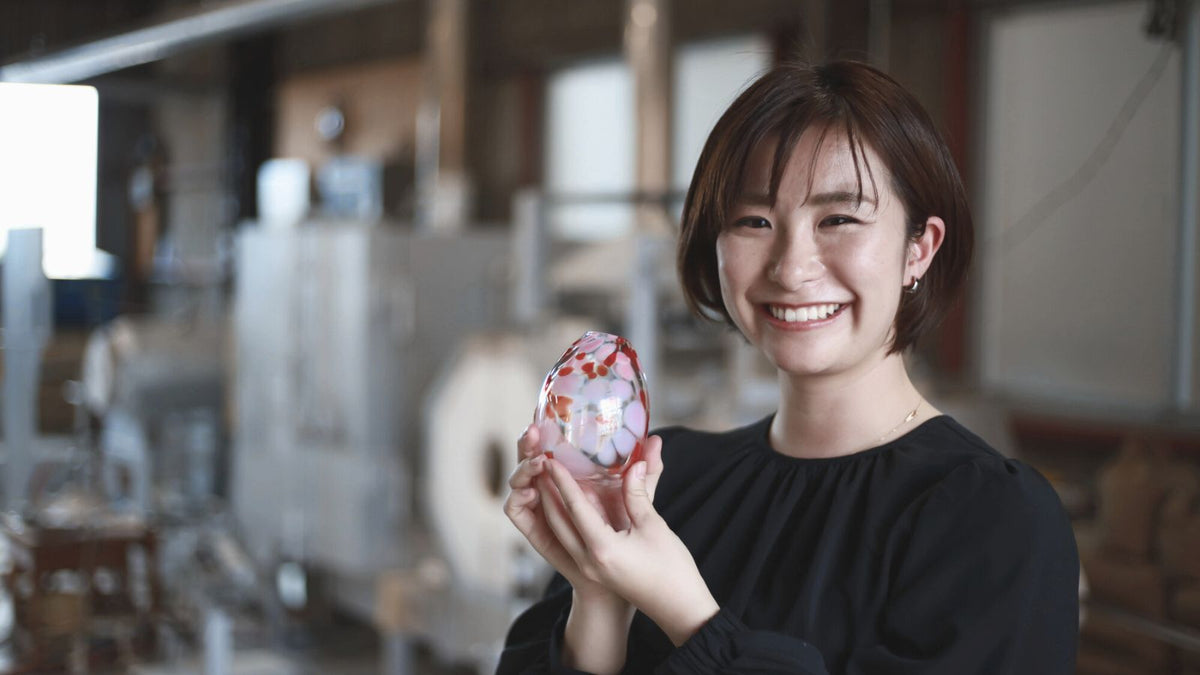 Japanese lady holding a artisan glass