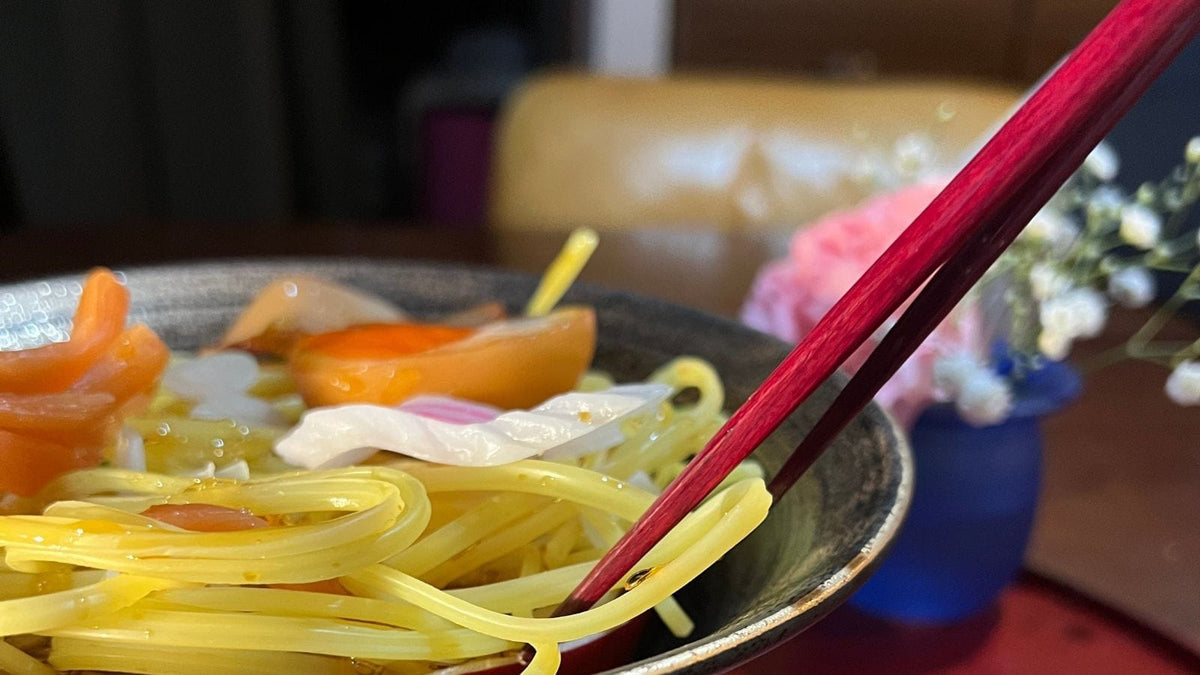 A bowl of ramen with chopsticks